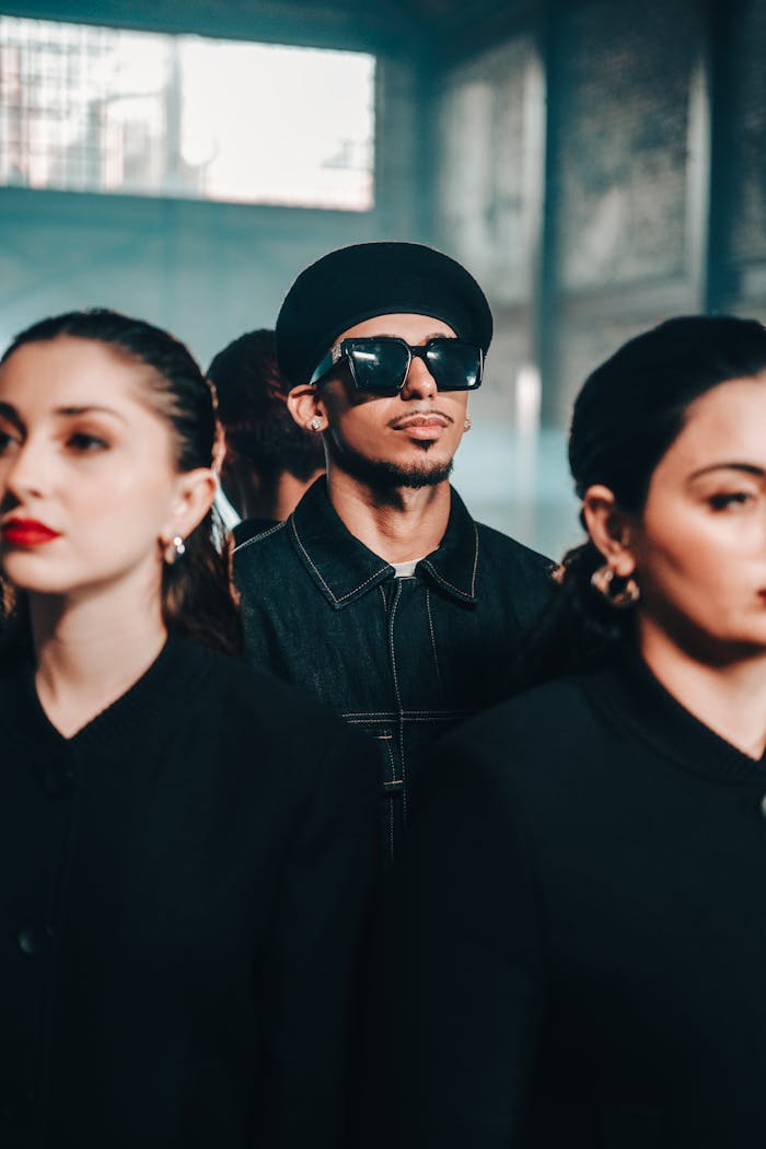 Fashionable group of adults posing indoors with a trendy and modern vibe.